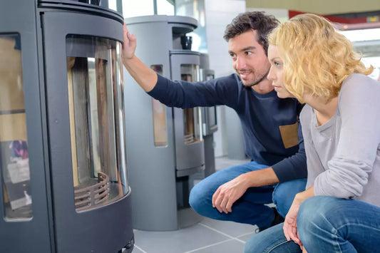 Man and woman examining a modern furnace display to compare features and energy efficiency